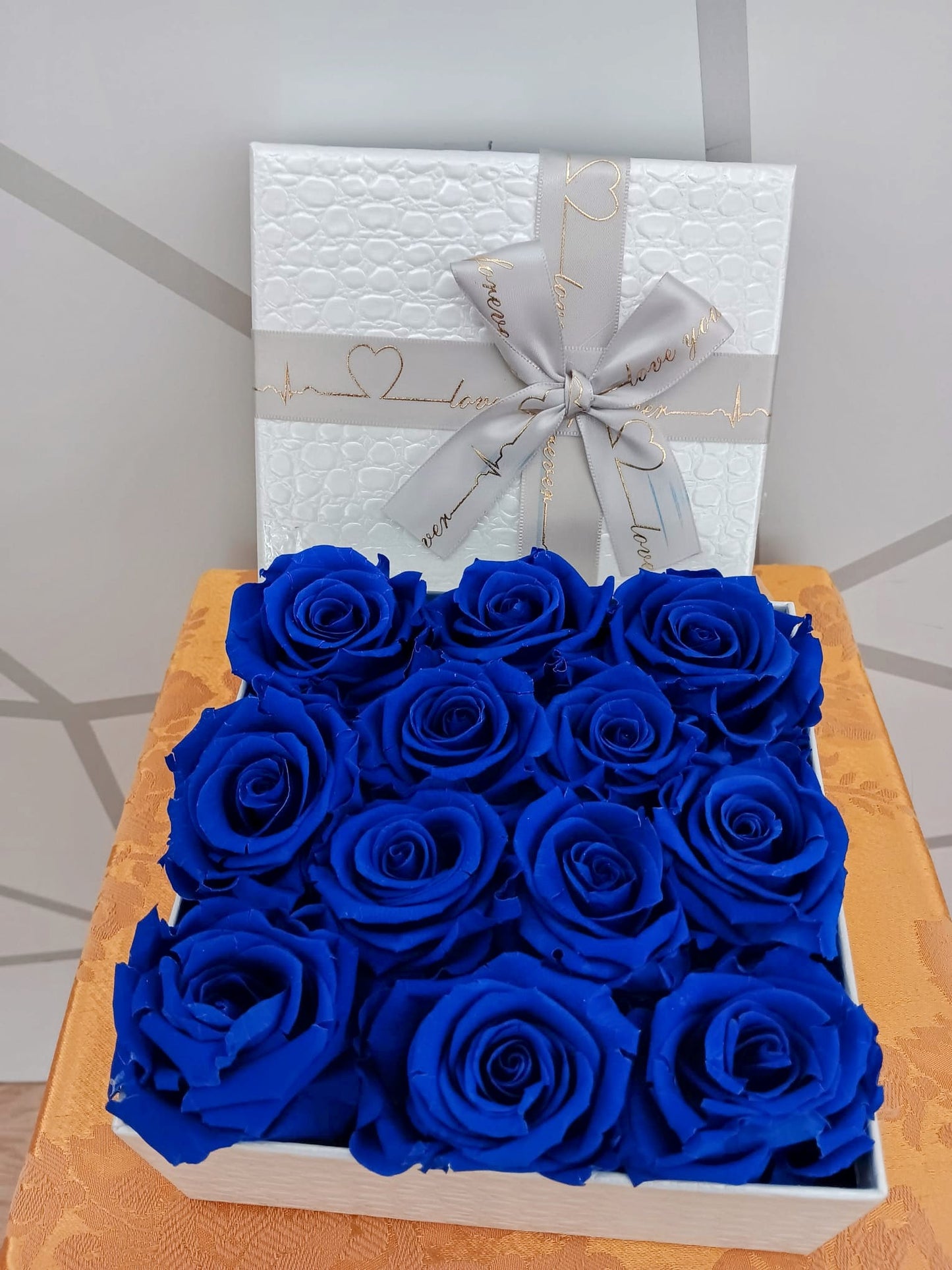 Box with preserved blue roses