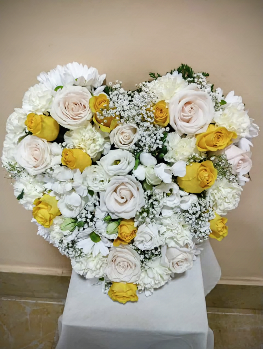 Heart with pastel roses and flowers in pastel tones